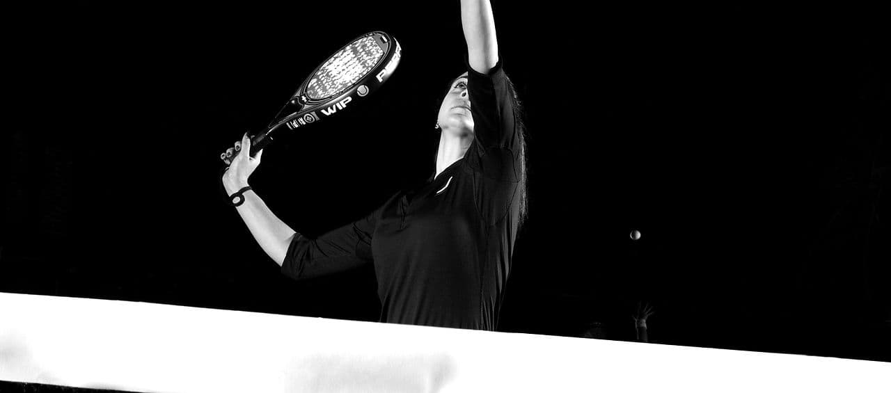 Padel player serving